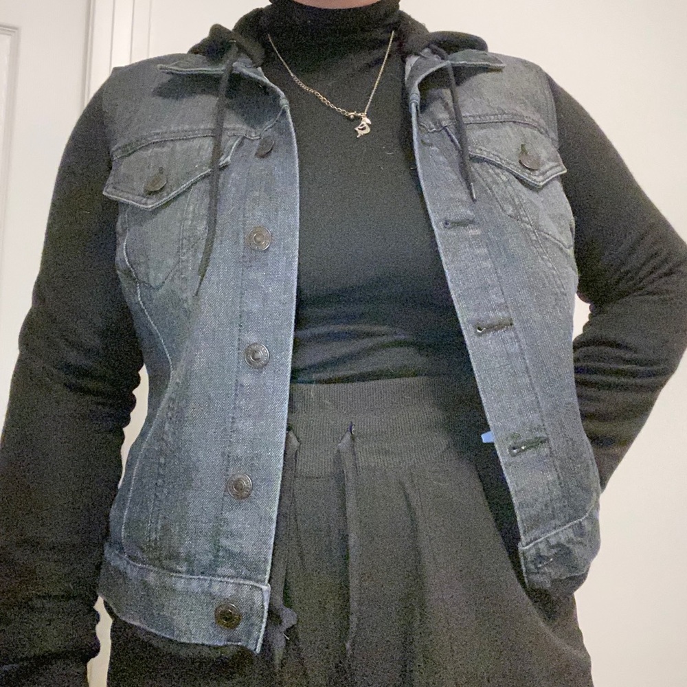 Dark wash jean jacket with fleece sleeves and hood